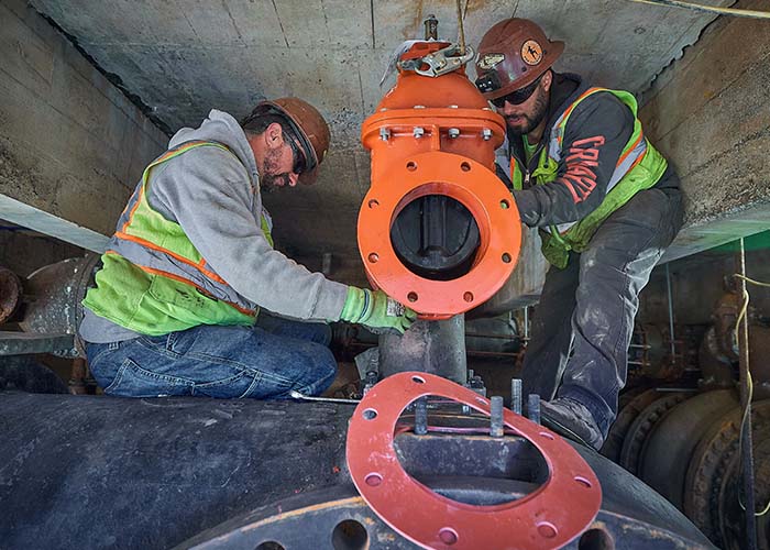 Two J Fletcher employees working in pump station